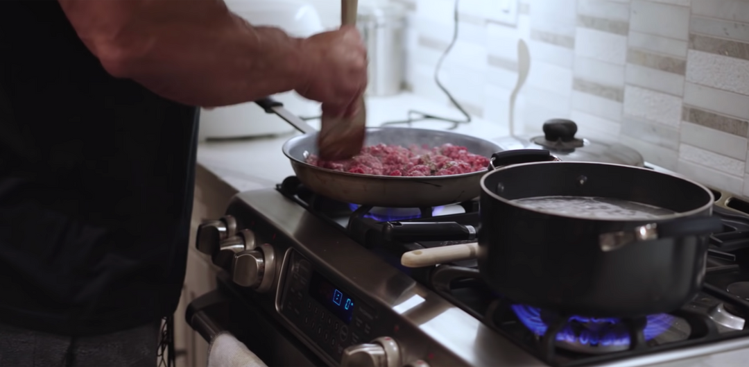 Bodybuilder Fouad Abiad cooking ground beef in a pan