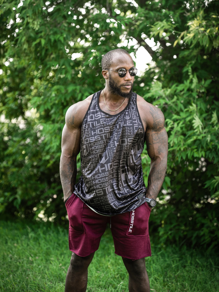 Bodybuilder wearing the Classic Raw shorts#color_cherry