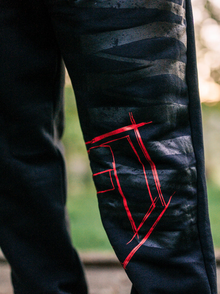 Bodybuilder wearing the Defiant Straight Leg Jogger#color_black