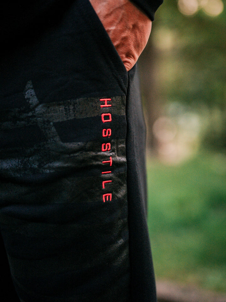 Bodybuilder wearing the Defiant Straight Leg Jogger#color_black