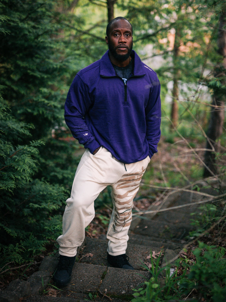 Bodybuilder wearing the Defiant Straight Leg Jogger#color_off-white