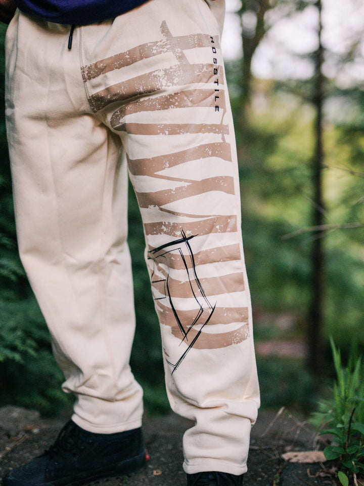 Bodybuilder wearing the Defiant Straight Leg Jogger#color_off-white