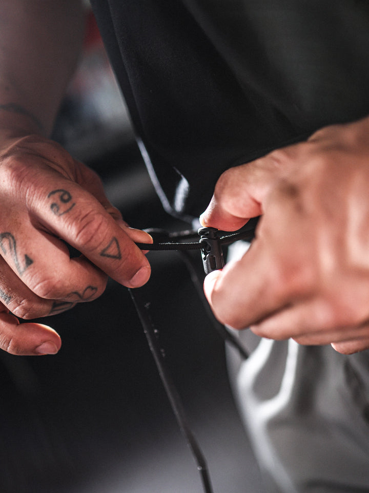 Bodybuilder wearing Gym Cargo Pants#color_charcoal