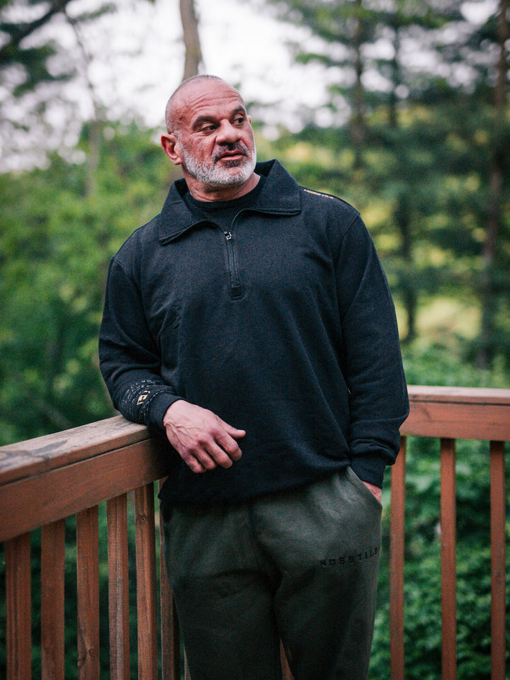 Bodybuilder wearing the Halo Quarter Zip Sweatshirt#color_black