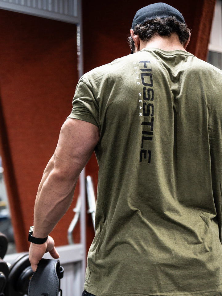Bodybuilder wearing OG Sacrifice Classic Workout T-Shirt#color_military-green