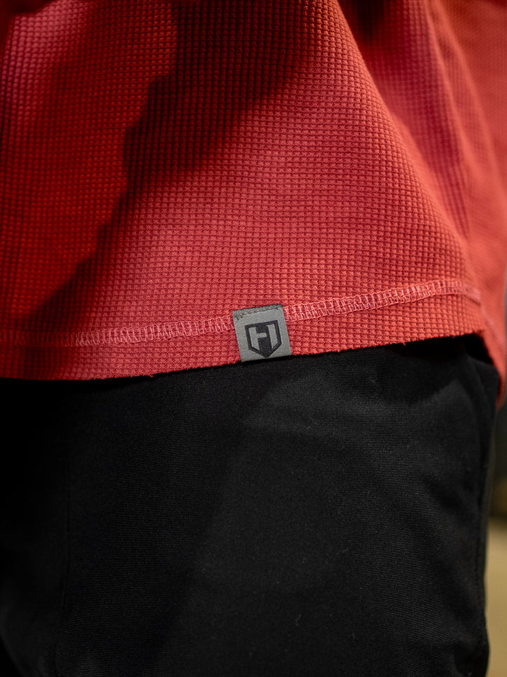 Bodybuilder wearing Shield Thermal Shirt#color_flat-red
