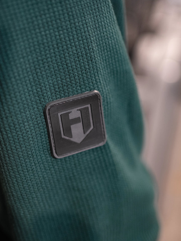 Bodybuilder wearing Shield Thermal Shirt#color_forest-green