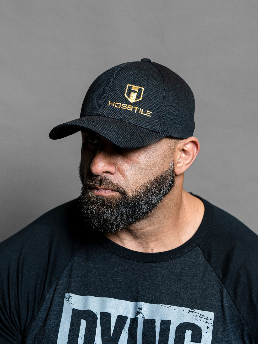 Hosstile Gold Logo FlexFit Hat - Model Bodybuilder Fouad Abiad