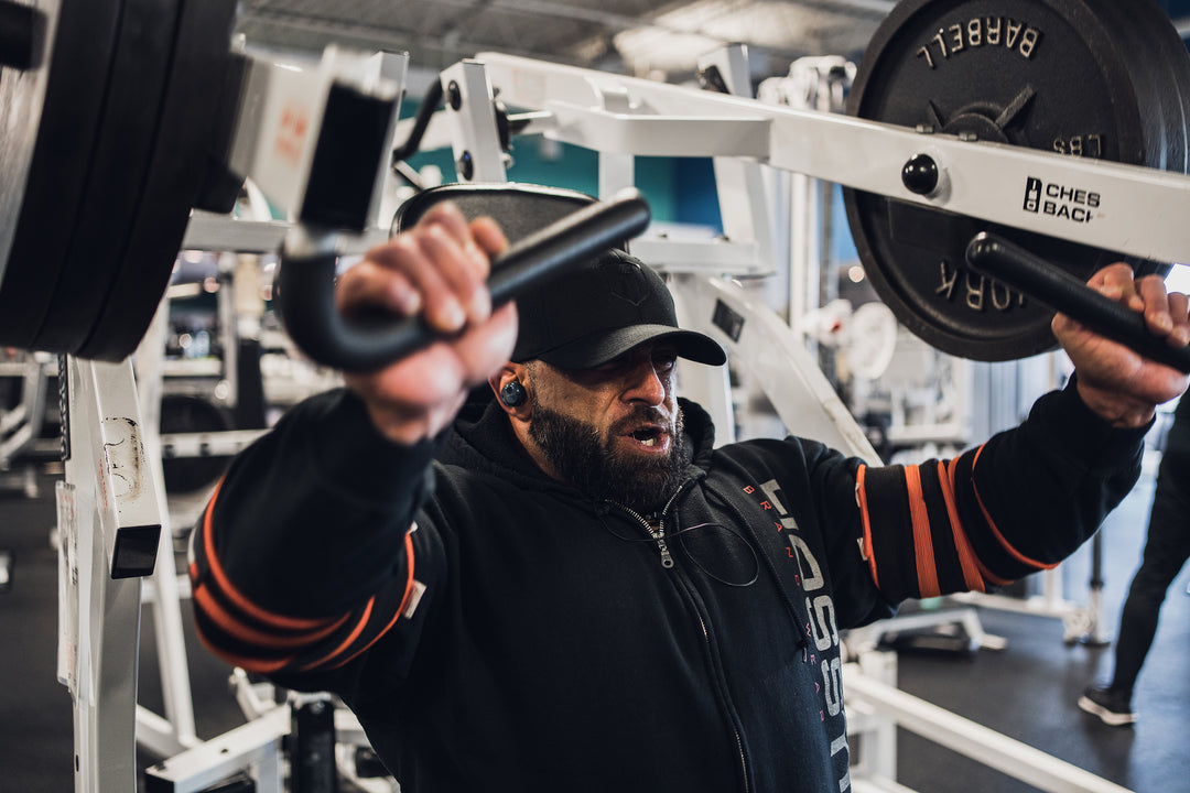 Bodybuilder Fouad Abiad training chest with chest press machine in gym