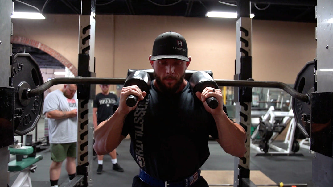 Bodybuilder Nathan Epler squatting in gym