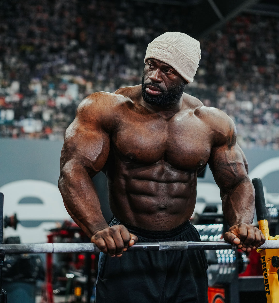 Bodybuilder Samson Dauda training shoulders in the gym
