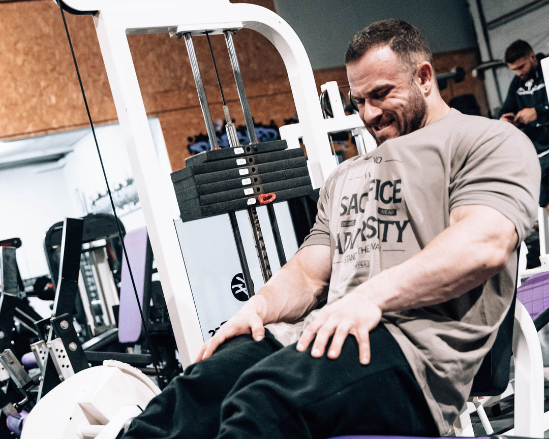 Bodybuilder Dean White training legs on leg extension machine