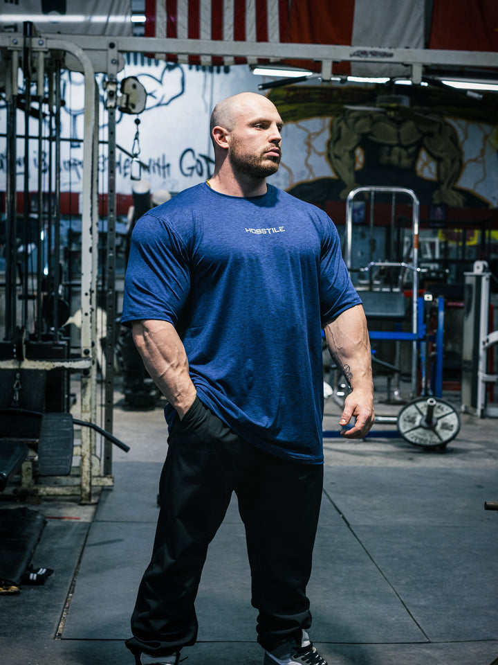 Bodybuilder Martin Fitzwater wearing the Hosstile Athletic Tee in the gym#color_steel-blue