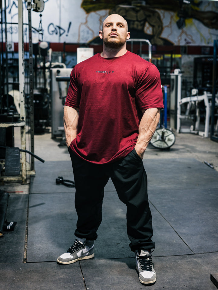 Bodybuilder Martin Fitzwater wearing the Hosstile Athletic Tee in the gym#color_flat-red