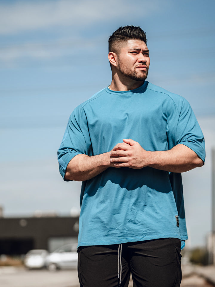 Bodybuilder wearing an oversized workout t-shirt