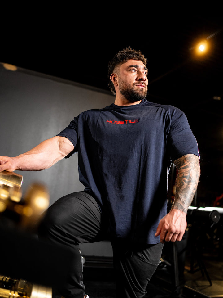 Bodybuilder wearing the Bodybag Oversized Tee#color_navy-red