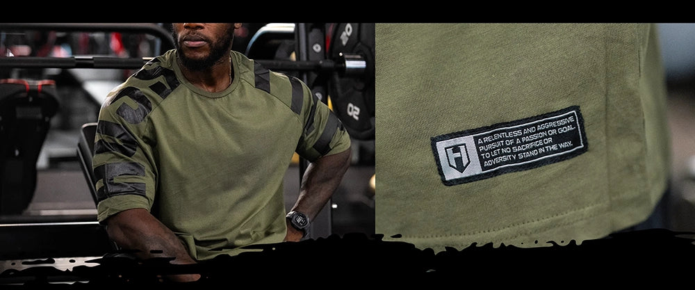 Bodybuilder wearing a green Hosstile oversized t-shirt for training with a patch, close-up of the patch on the right.