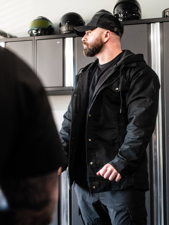 Bodybuilder wearing the Canvas Work Jacket#color_black