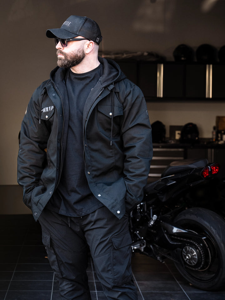 Bodybuilder wearing the Canvas Work Jacket#color_black