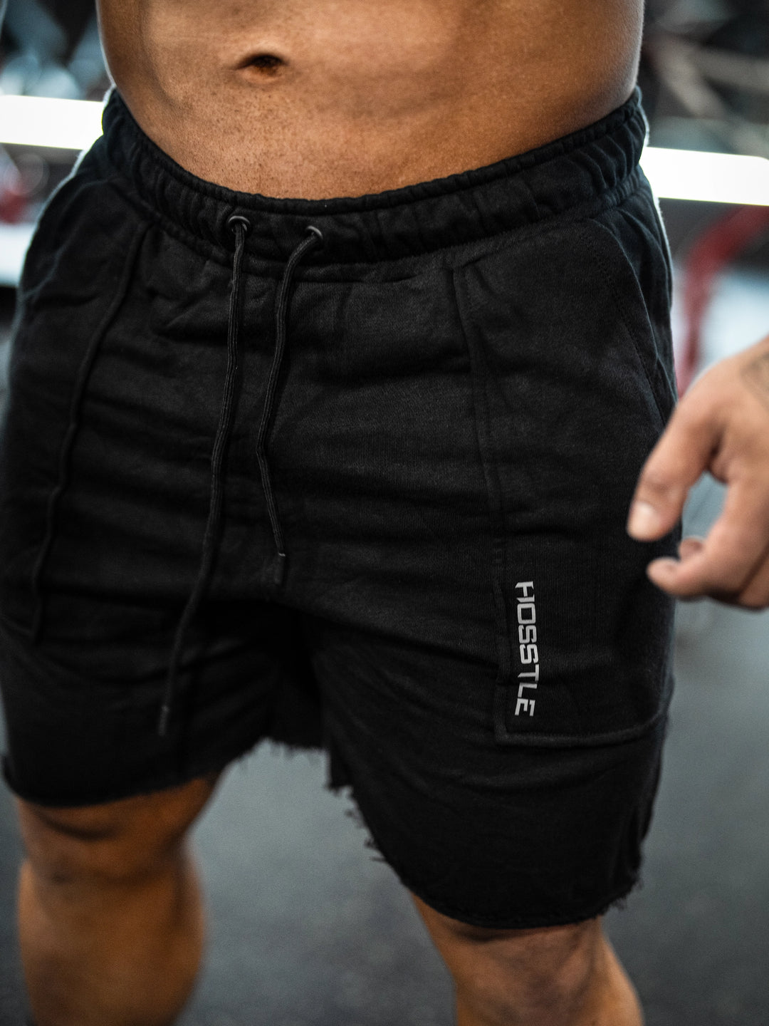 Bodybuilder wearing the Classic Raw shorts#color-black