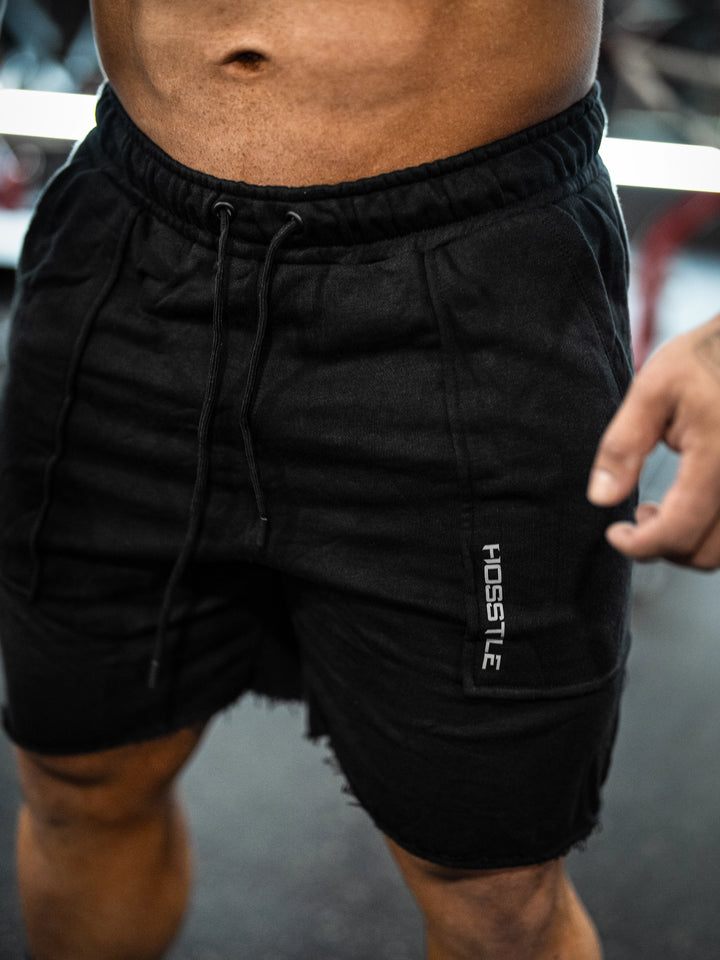 Bodybuilder wearing the Classic Raw shorts#color-black