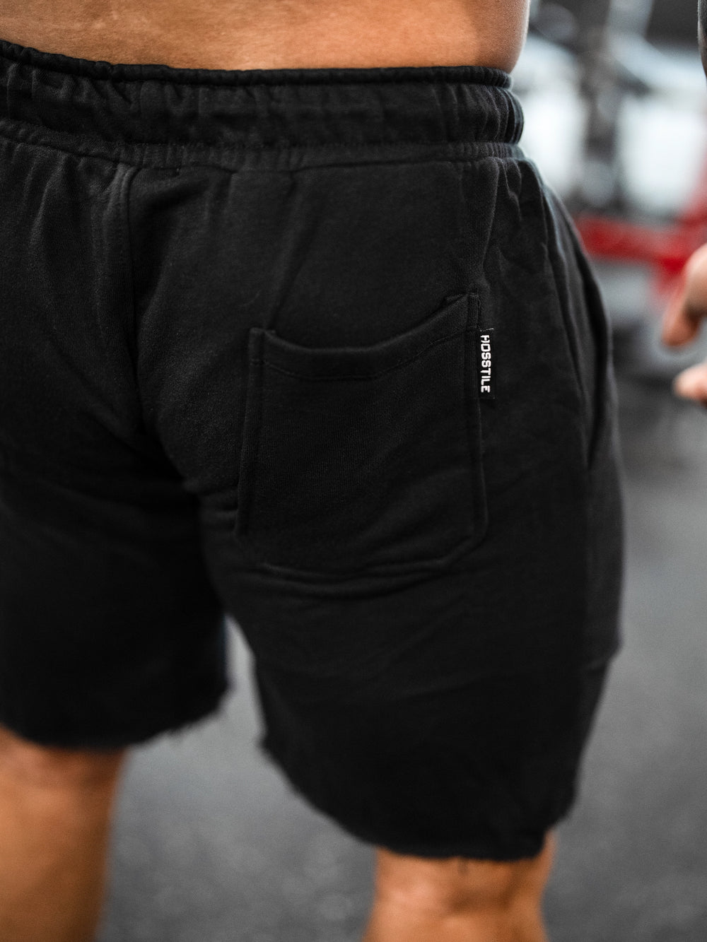 Bodybuilder wearing the Classic Raw shorts#color-black