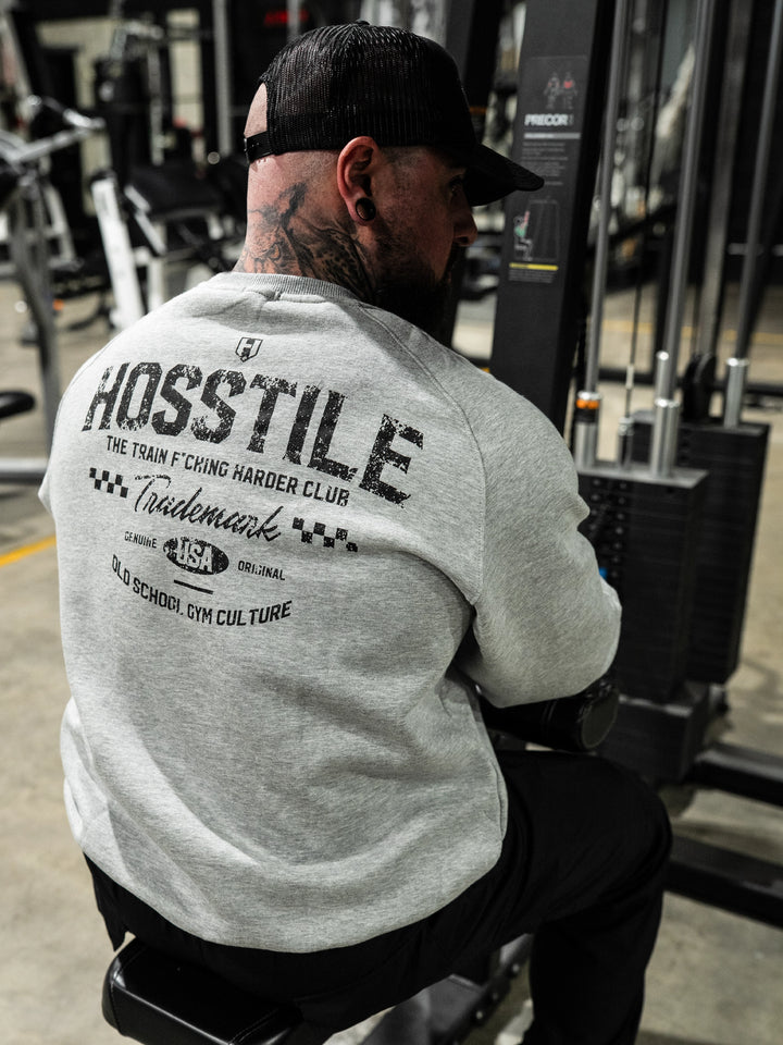 Bodybuilder wearing the Hosstile Club Crew Sweatshirt#color_heather-cement