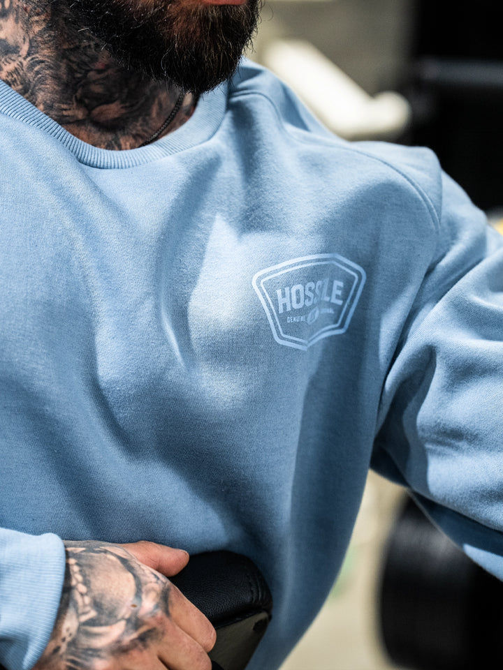 Bodybuilder wearing the Hosstile Club Crew Sweatshirt#color_smoke-blue