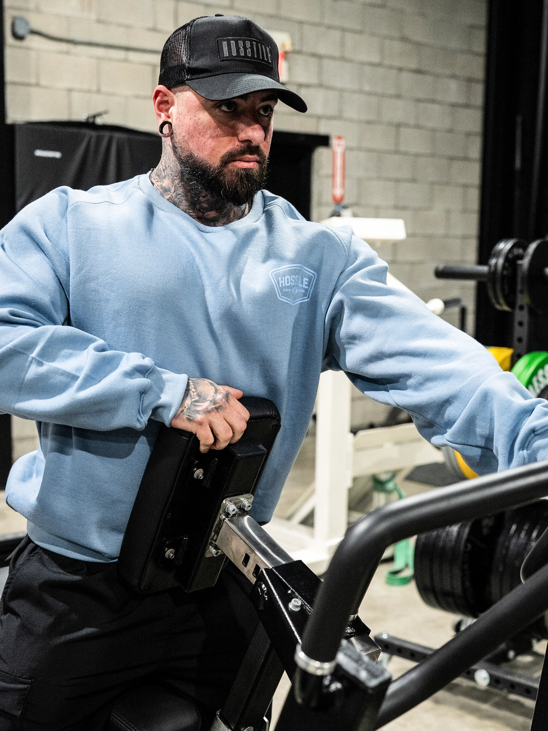 Bodybuilder wearing the Hosstile Club Crew Sweatshirt#color_smoke-blue