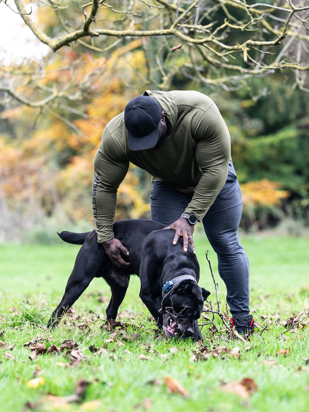 Bodybuilder Samson Dauda wearing the Core Pullover Hoodie#color_rifle-green