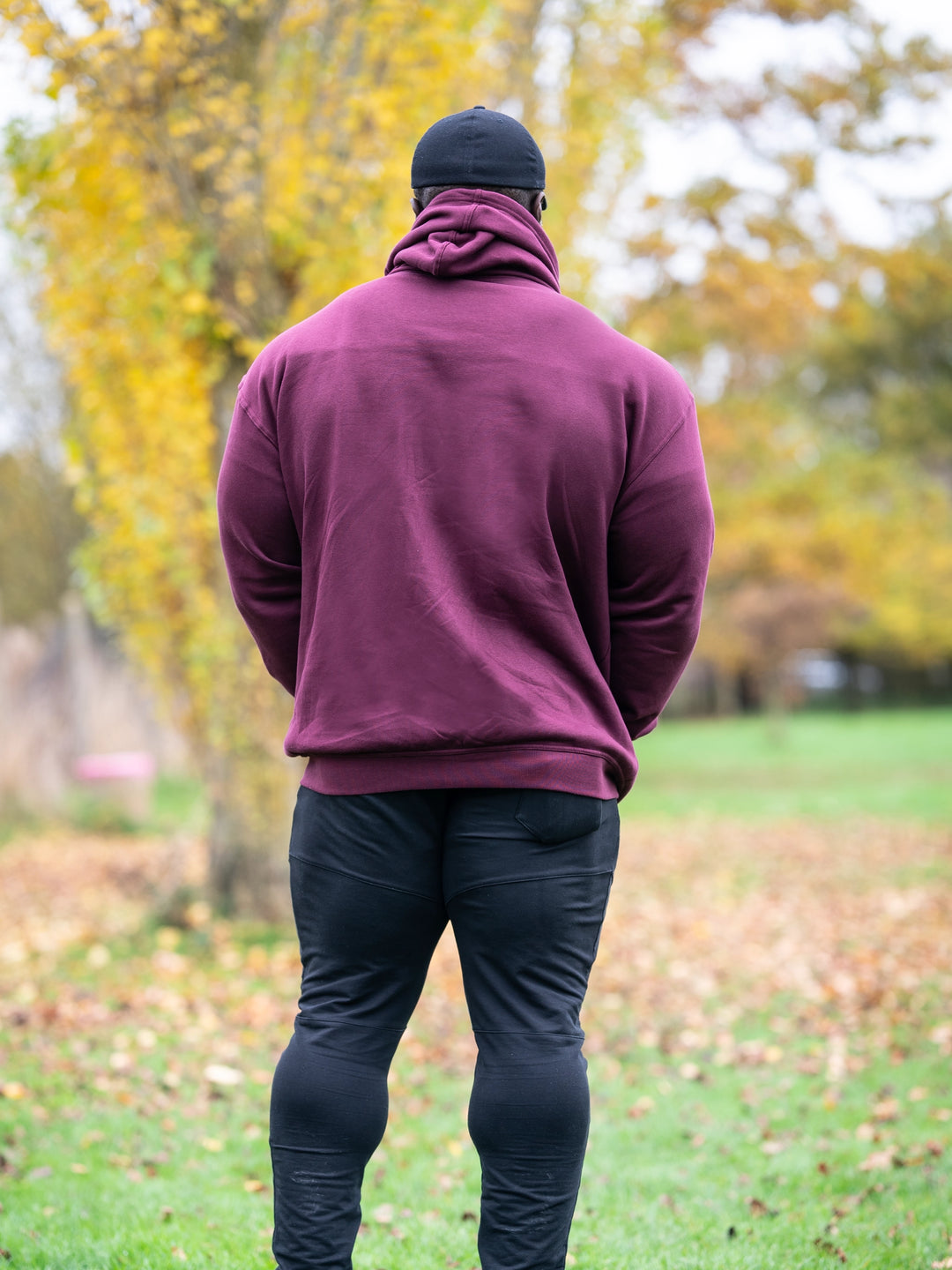 Bodybuilder Samson Dauda wearing Culture Zip-Up Hoodie#color_black-currant