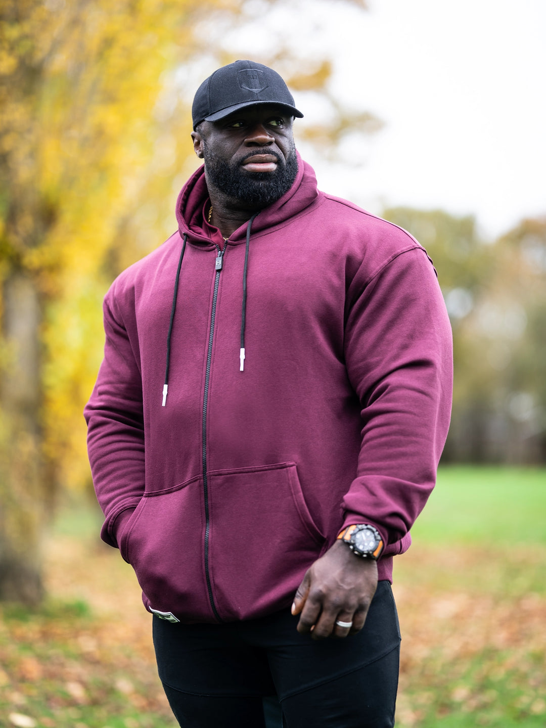 Bodybuilder Samson Dauda wearing Culture Zip-Up Hoodie#color_black-currant