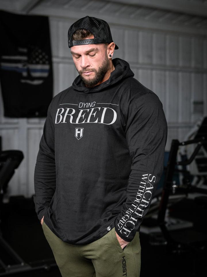 Bodybuilder wearing a lightweight pullover hoodie t-shirt in the gym#color_black
