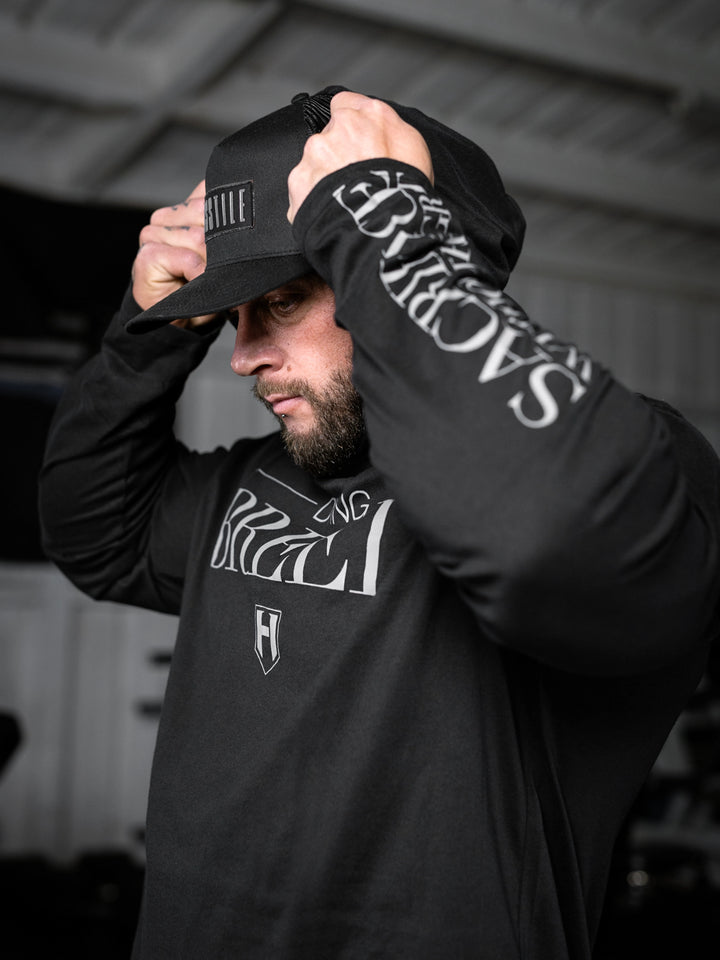 Bodybuilder wearing a lightweight pullover hoodie t-shirt in the gym#color_black