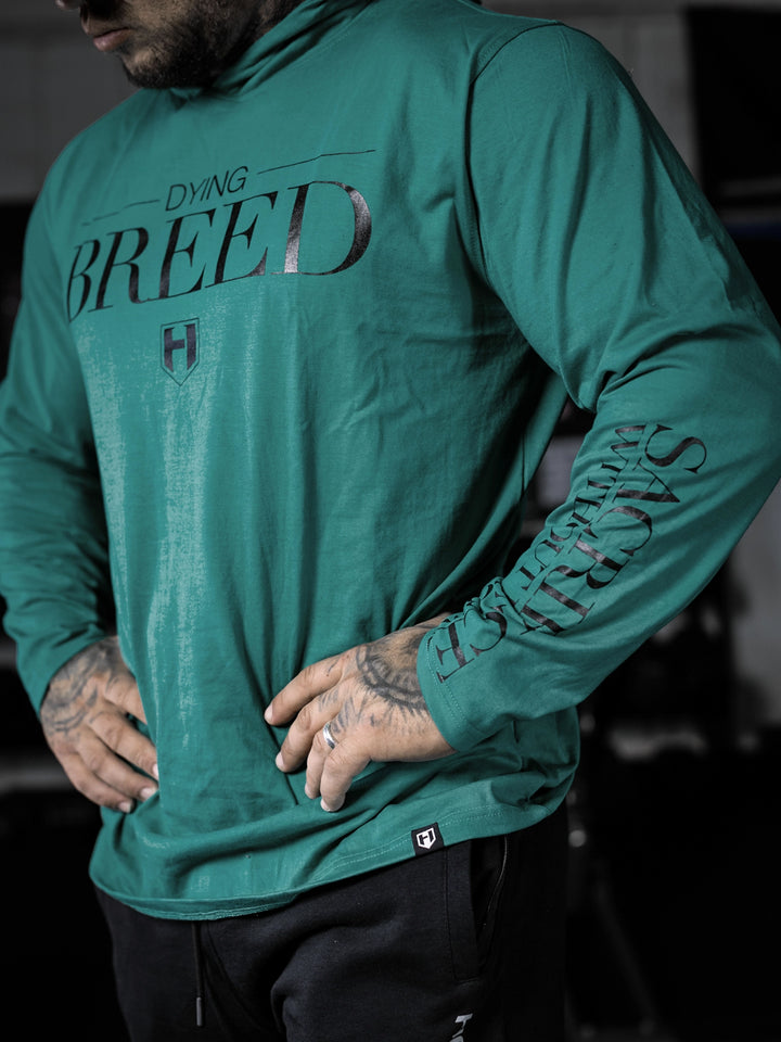 Bodybuilder wearing a lightweight pullover hoodie t-shirt in the gym#color_dark-teal