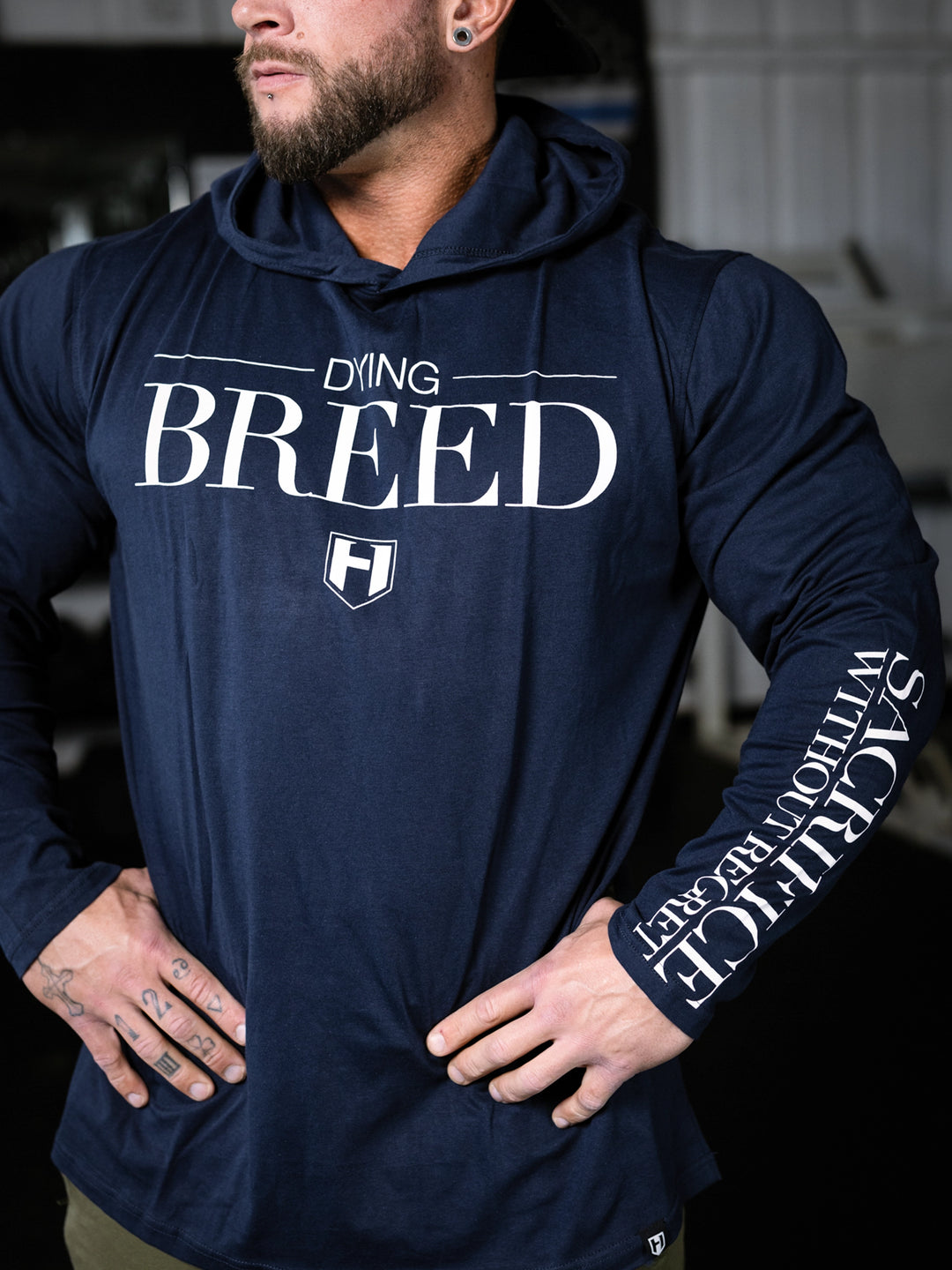 Bodybuilder wearing a lightweight pullover hoodie t-shirt in the gym#color_navy