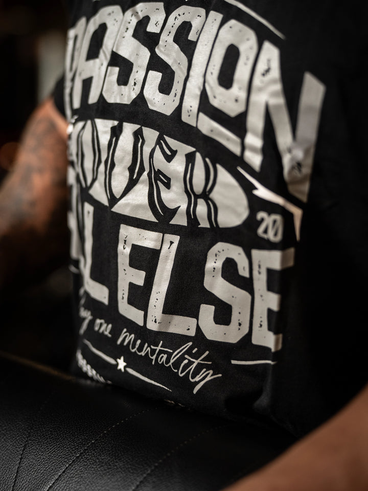 Black t-shirt with white text on a person wearing it#color_black