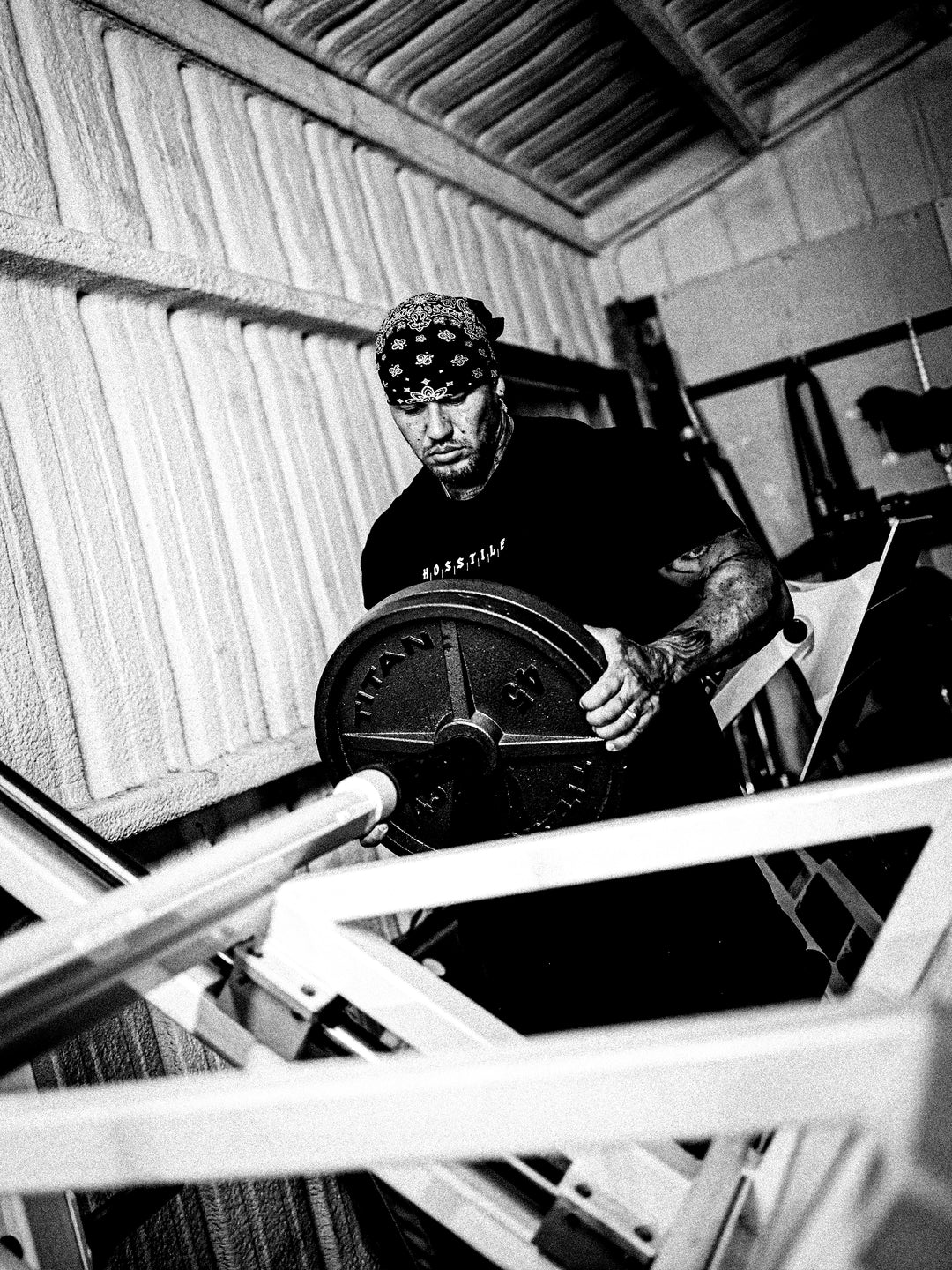 Bodybuilder wearing the Divided Gym T-shirt while training#color_black