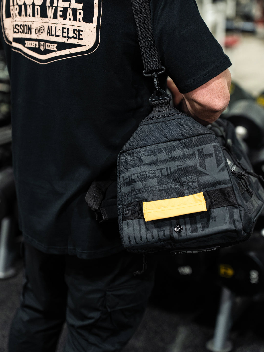 bodybuilder carrying the Hosstile Duffel Backpack in the gym