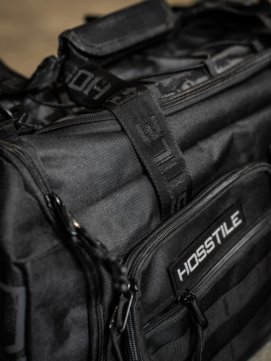 bodybuilder carrying the Hosstile Duffel Backpack in the gym