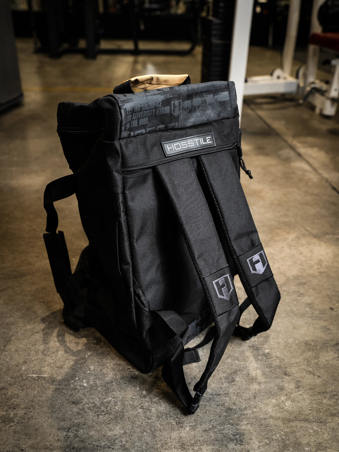 bodybuilder carrying the Hosstile Duffel Backpack in the gym