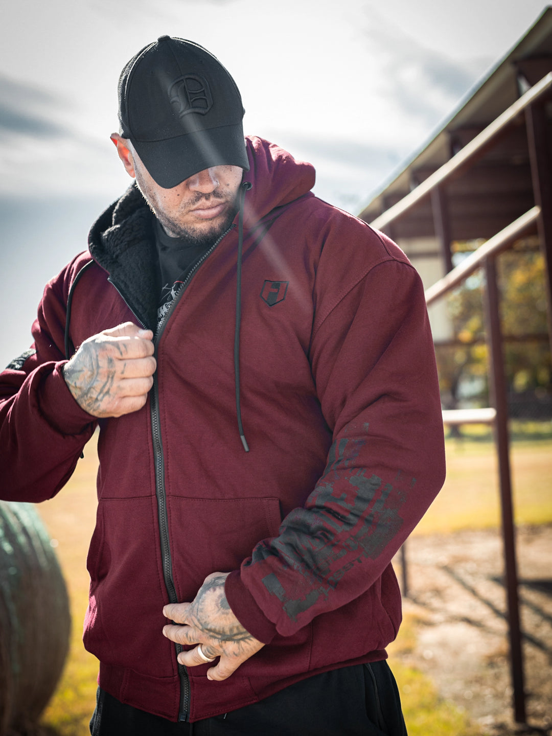 Bodybuilder wearing the Endure 2.0 Sherpa Hoodie#color_deep-cherry