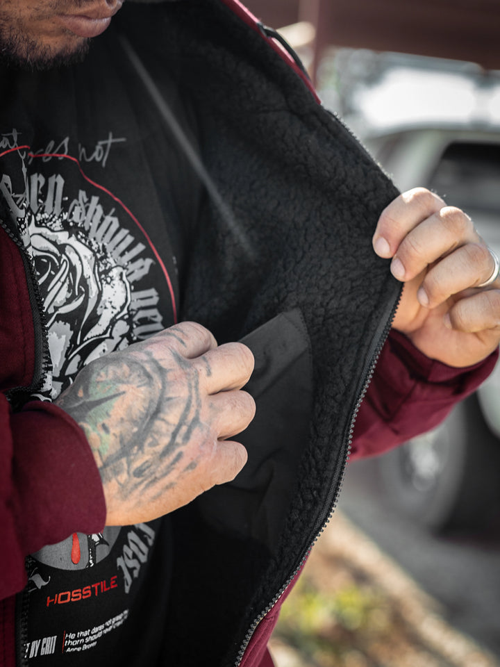 Bodybuilder wearing the Endure 2.0 Sherpa Hoodie#color_deep-cherry