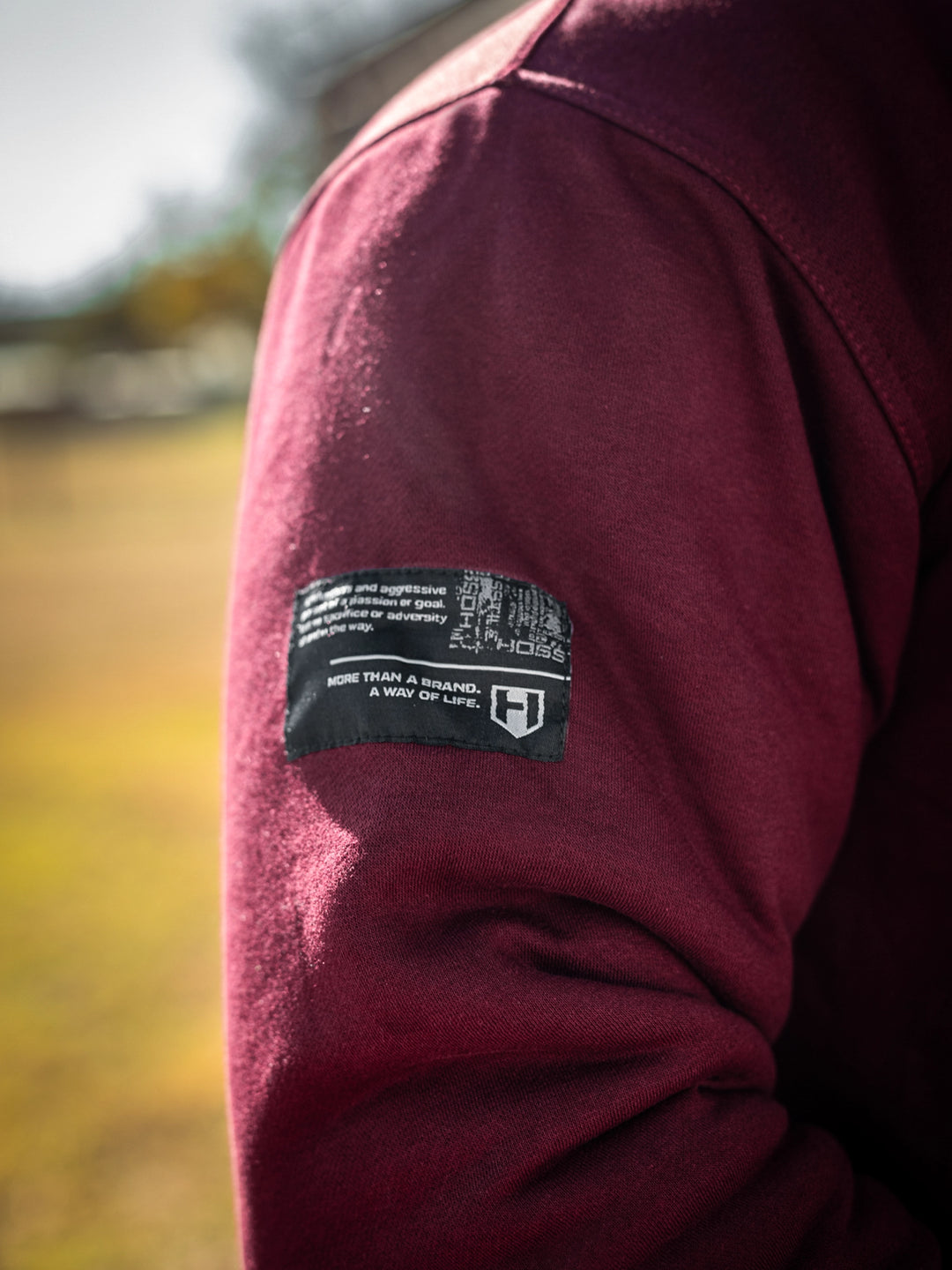 Bodybuilder wearing the Endure 2.0 Sherpa Hoodie#color_deep-cherry