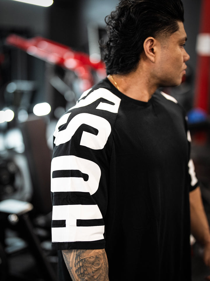Bodybuilder wearing the Expansion Oversized Tee#color-black
