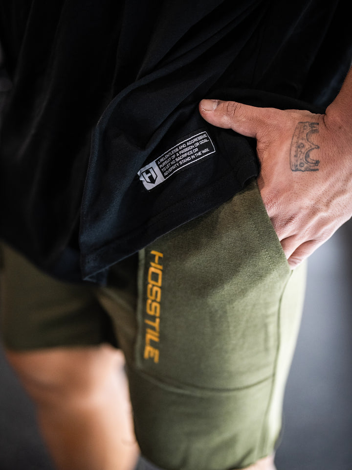 Bodybuilder wearing the Expansion Oversized Tee#color-black