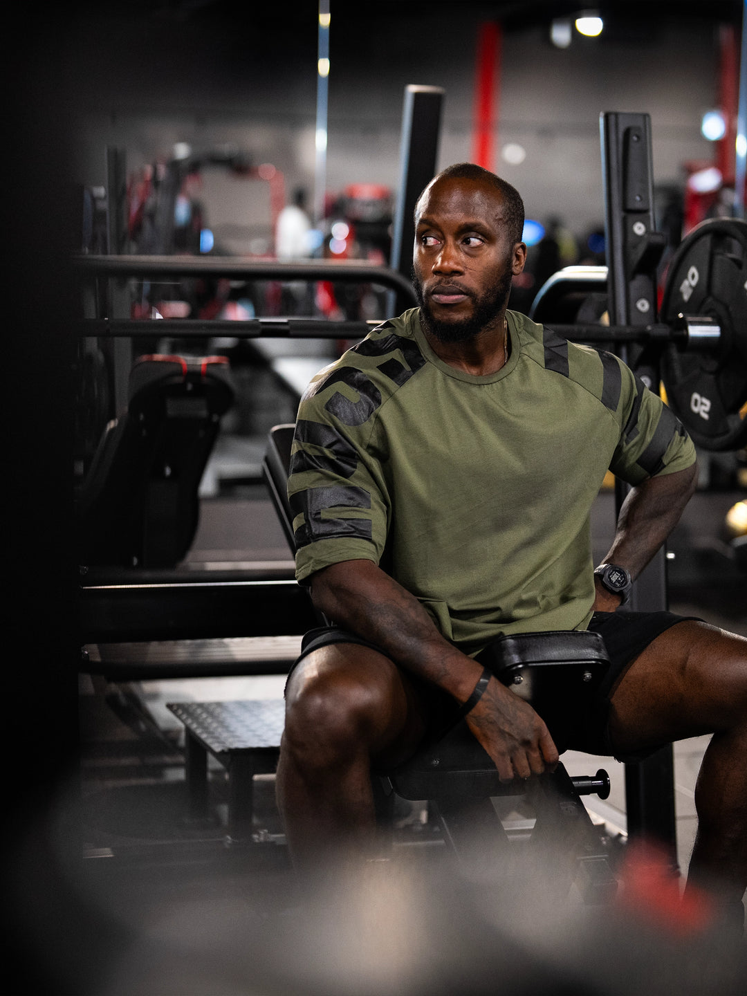 Bodybuilder wearing the Expansion Oversized Tee#color-military-green
