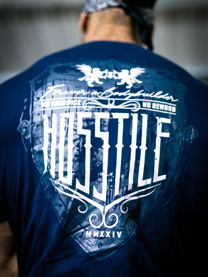 Bodybuilder Ben Chow standing in a gym wearing a t-shirt with text and graphics.#color_navy
