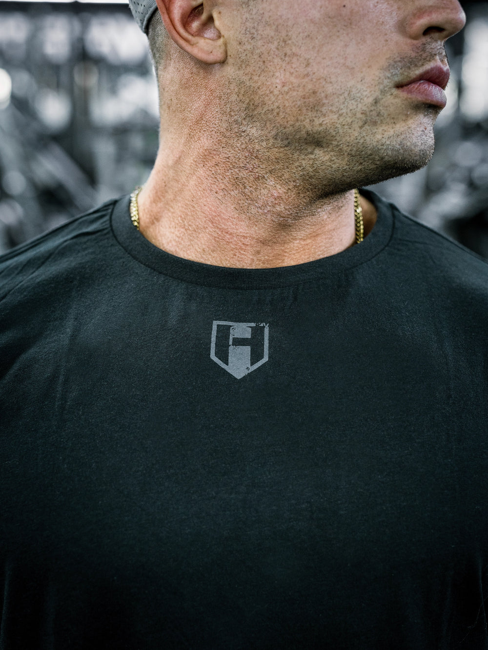 IFBB Pro Bodybuilder Martin Fitzwater wearing a black long-sleeve shirt with text in a gym setting#color_black