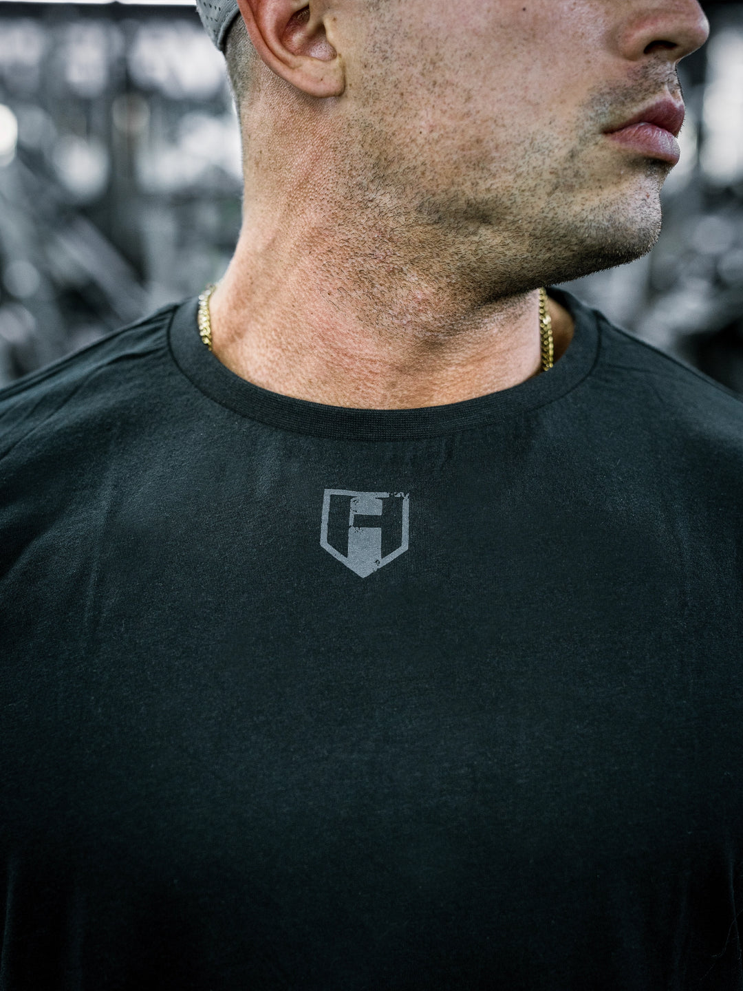 IFBB Pro Bodybuilder Martin Fitzwater wearing a black long-sleeve shirt with text in a gym setting#color_black